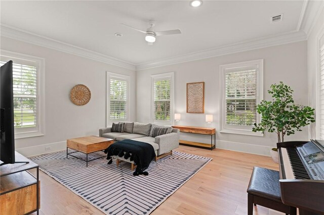 166 Robertson Cir, Saint Simons Island, GA 31522 - living room with ceiling fan, light wood-style floors, crown molding, and baseboards