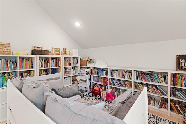 166 Robertson Cir, Saint Simons Island, GA 31522 - sitting room featuring vaulted ceiling, wall of books, recessed lighting, and wood finished floors