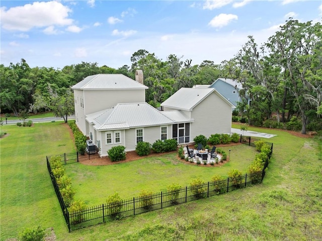 166 Robertson Cir, Saint Simons Island, GA 31522 - back of house with a chimney, metal roof, and view of scattered trees