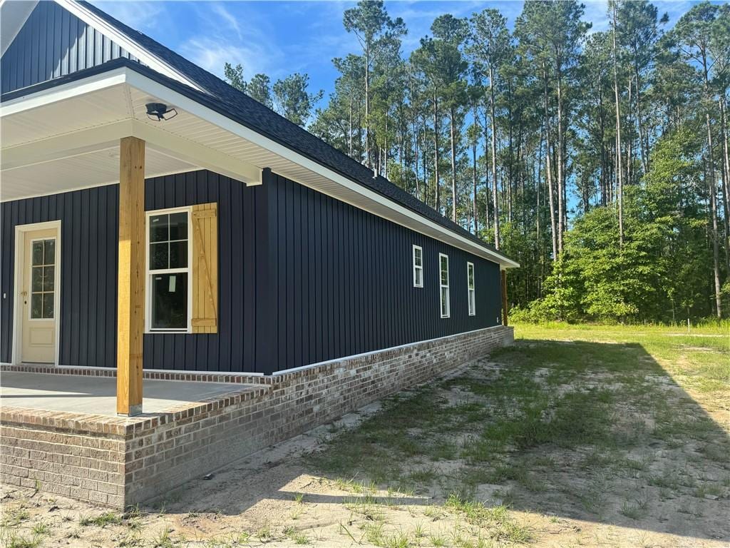 149 S Deborah Cir, Jesup, GA 31546 - view of property exterior with board and batten siding