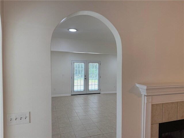 208 Stafford Ave, Brunswick, GA 31520 - hallway featuring arched walkways, light tile patterned flooring, and french doors
