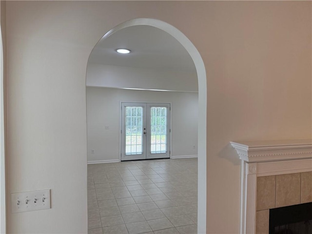 208 Stafford Ave, Brunswick, GA 31520 - hallway featuring arched walkways, light tile patterned flooring, and french doors