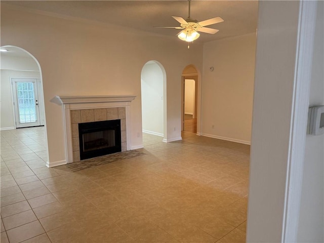 208 Stafford Ave, Brunswick, GA 31520 - unfurnished living room with arched walkways, a ceiling fan, and a fireplace