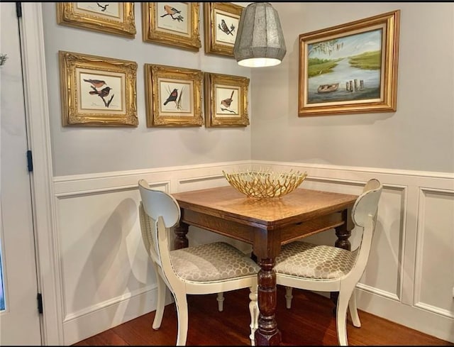 dining space with wood-type flooring