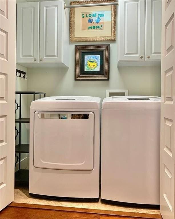 washroom with cabinets and independent washer and dryer