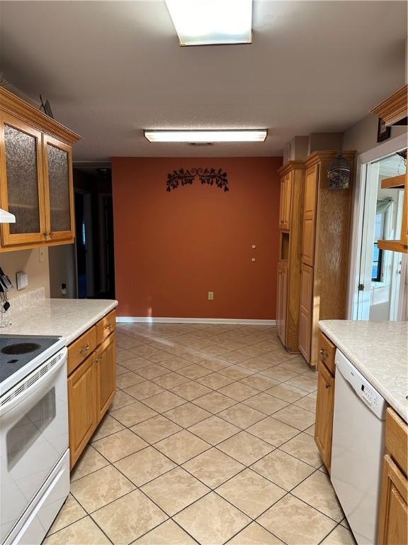 kitchen featuring white appliances and light tile patterned flooring