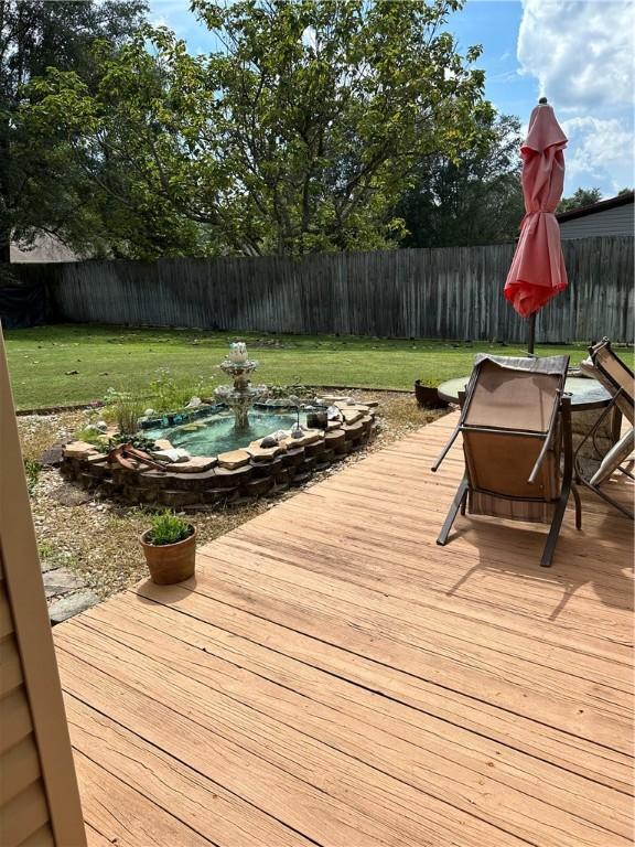 wooden terrace with a yard