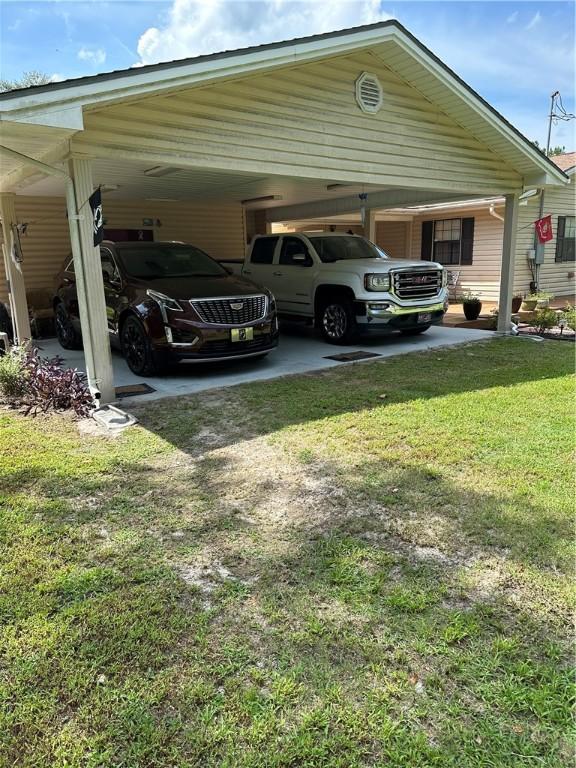 view of car parking featuring a yard and a carport