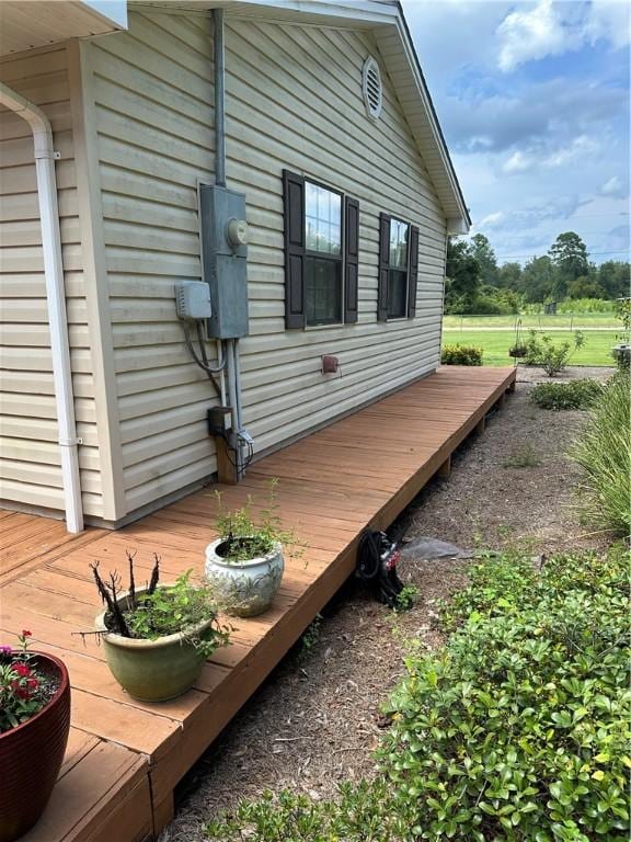 view of side of home with a wooden deck