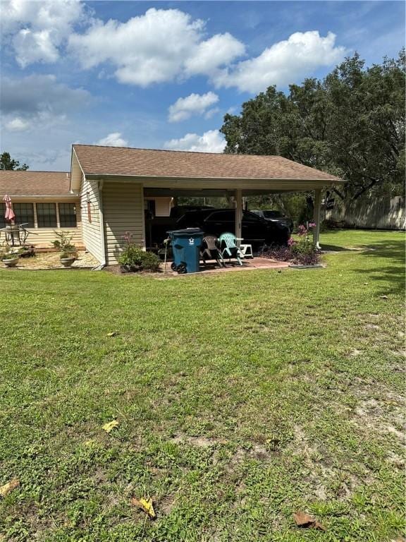 exterior space featuring a lawn and a carport