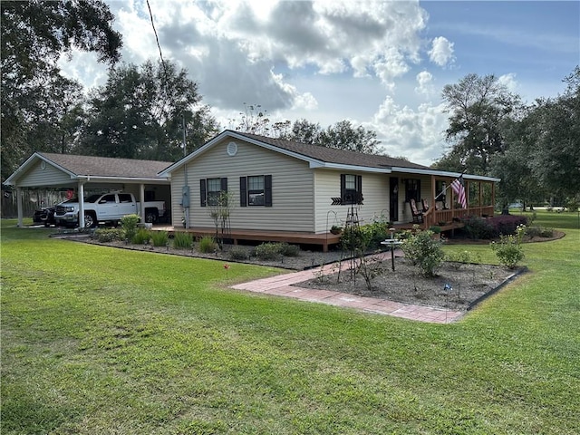 rear view of house featuring a carport and a lawn