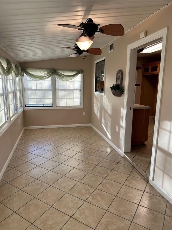 tiled spare room with plenty of natural light, wooden ceiling, and ceiling fan