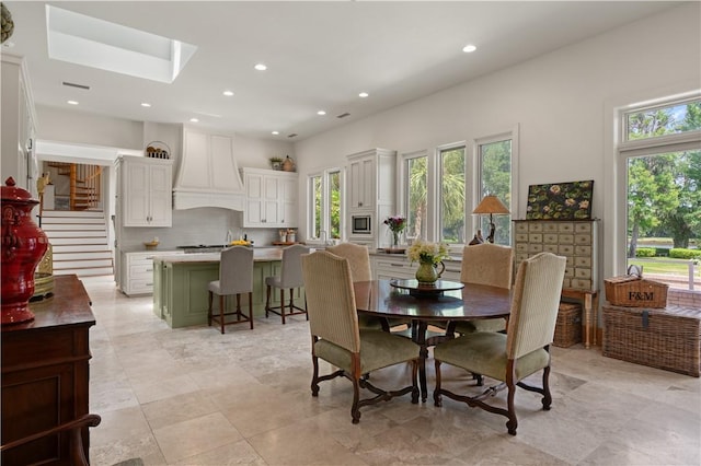 dining space with a skylight and a healthy amount of sunlight