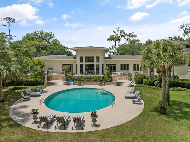 rear view of property with a yard and a patio