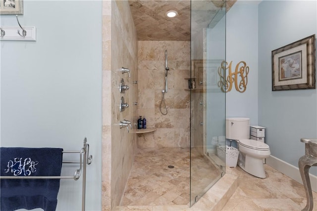 bathroom with toilet and a shower with shower door