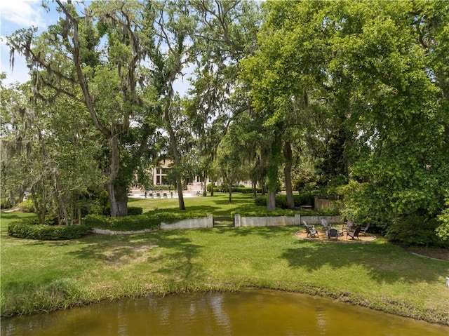 view of community with a water view and a yard