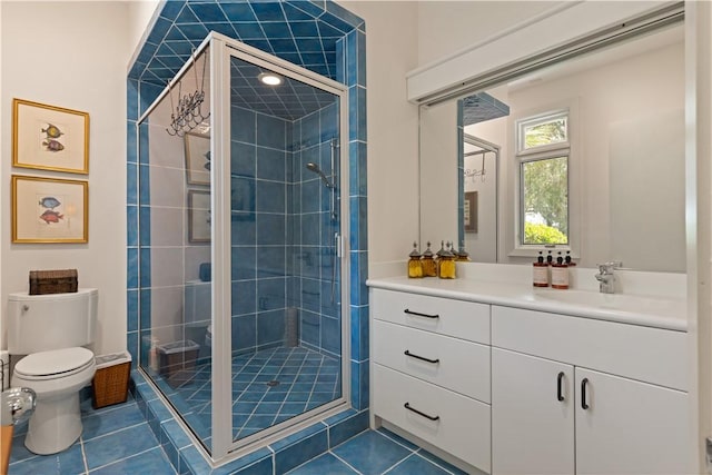 bathroom with toilet, vanity, tile patterned floors, and a shower with door