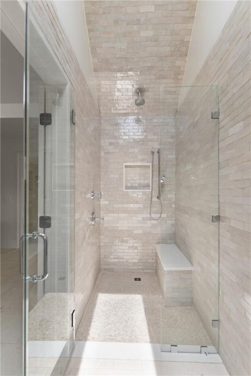 bathroom featuring a shower stall and lofted ceiling