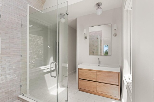 full bath with a shower stall, vanity, and tile patterned floors
