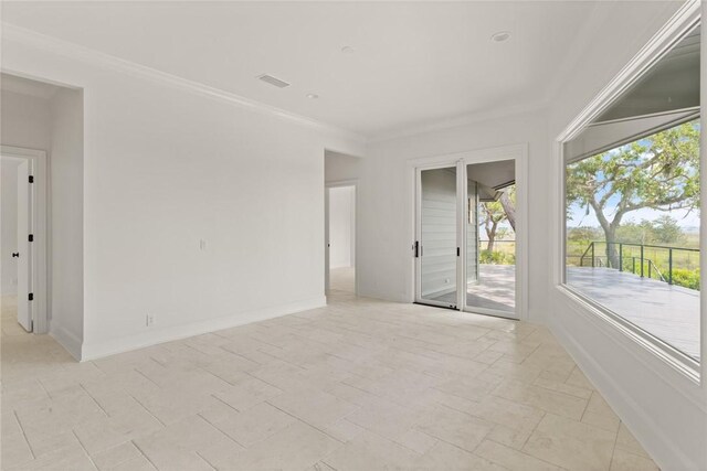spare room with visible vents, baseboards, and ornamental molding