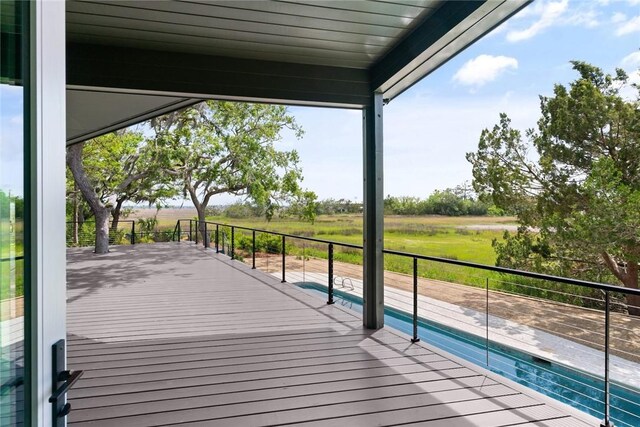 wooden deck featuring a fenced in pool