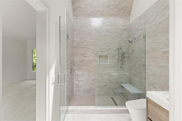 full bathroom featuring a shower stall, tile patterned flooring, toilet, vanity, and crown molding