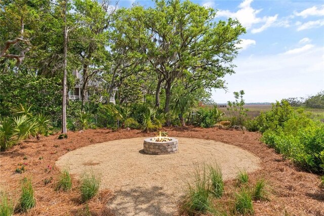 view of yard with an outdoor fire pit