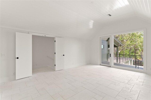 unfurnished room with lofted ceiling and visible vents