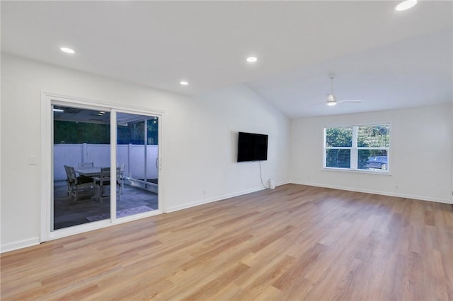 spare room featuring ceiling fan, vaulted ceiling, and light hardwood / wood-style flooring