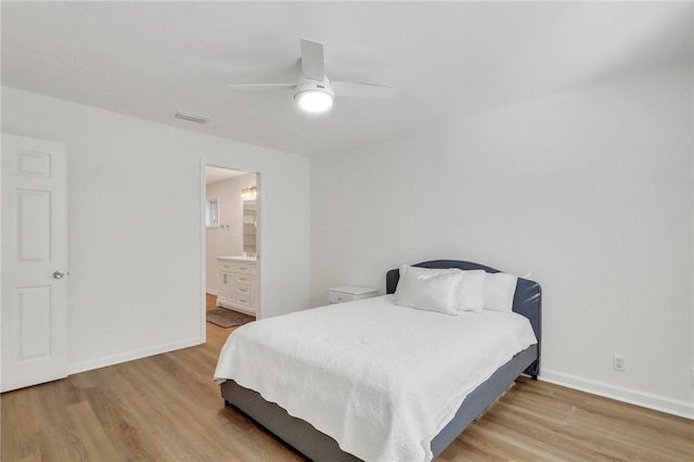 bedroom with ensuite bath, light hardwood / wood-style flooring, and ceiling fan