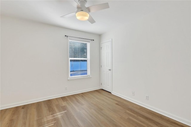 spare room featuring light hardwood / wood-style flooring and ceiling fan