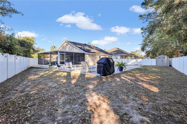 back of house with a sunroom and a shed