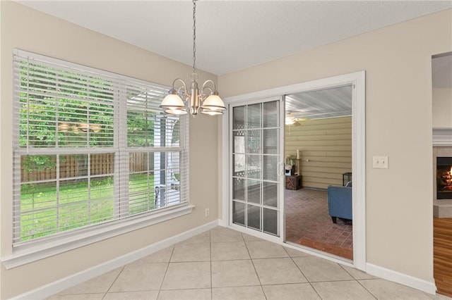 172 Autumns Ridge Ct, Brunswick, GA 31525 - unfurnished dining area featuring light tile patterned flooring, a chandelier, and a fireplace