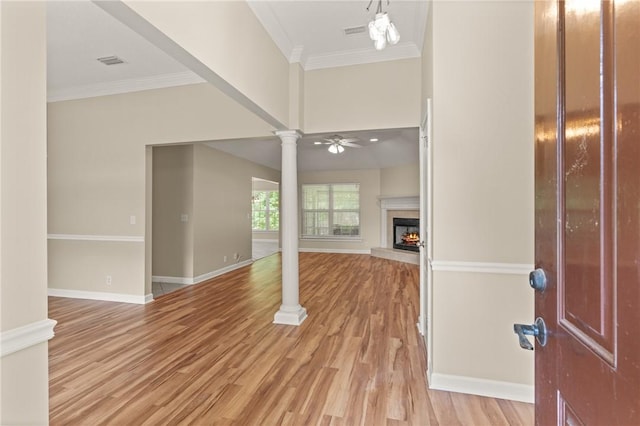 172 Autumns Ridge Ct, Brunswick, GA 31525 - entryway with ornate columns, a warm lit fireplace, crown molding, light wood-type flooring, and ceiling fan