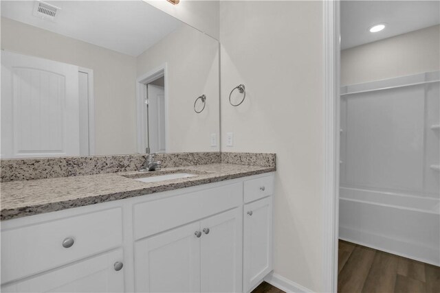 bathroom with hardwood / wood-style floors and vanity