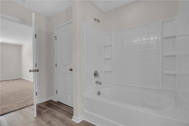 bathroom with wood-type flooring and  shower combination