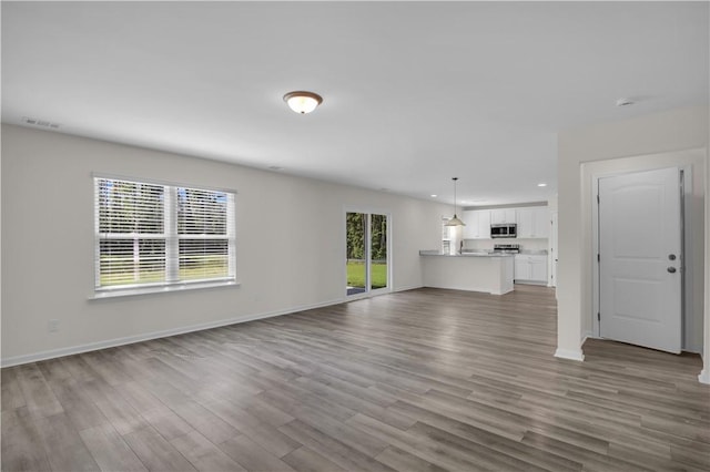 unfurnished living room with wood-type flooring