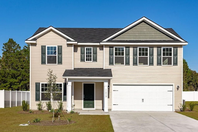 view of front of home with a front lawn and a garage