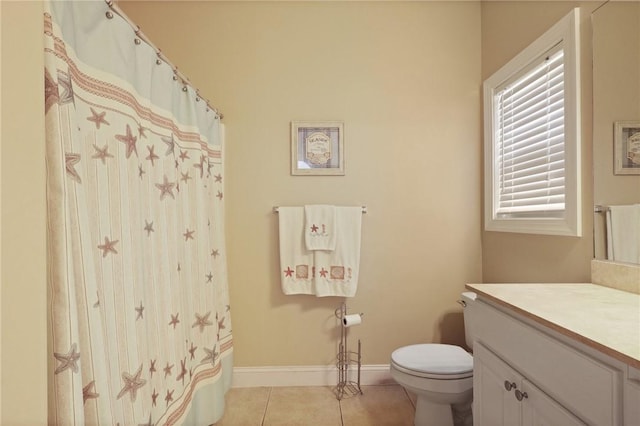 full bathroom featuring toilet, tile patterned floors, baseboards, and vanity