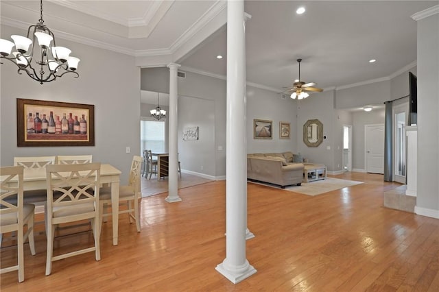 dining area with light wood-type flooring, recessed lighting, decorative columns, and ceiling fan with notable chandelier
