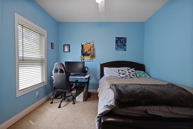 carpeted bedroom with a ceiling fan and baseboards