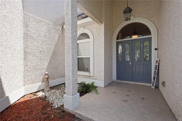 doorway to property with french doors and stucco siding