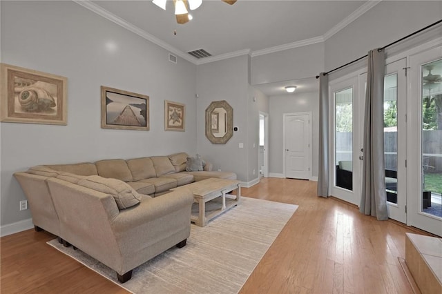 living area with a ceiling fan, visible vents, baseboards, light wood finished floors, and ornamental molding