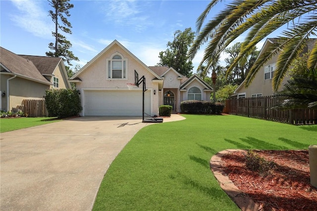 traditional-style home with a garage, fence, stucco siding, and driveway