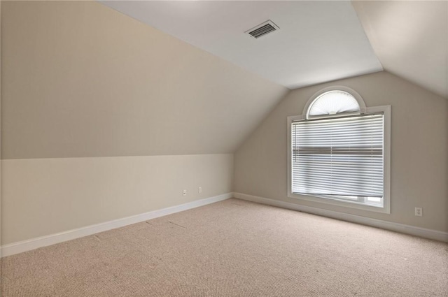 bonus room featuring baseboards, carpet, lofted ceiling, and visible vents