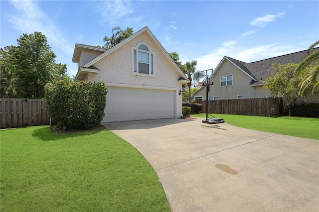 view of front of house with fence, stucco siding, concrete driveway, and a front lawn