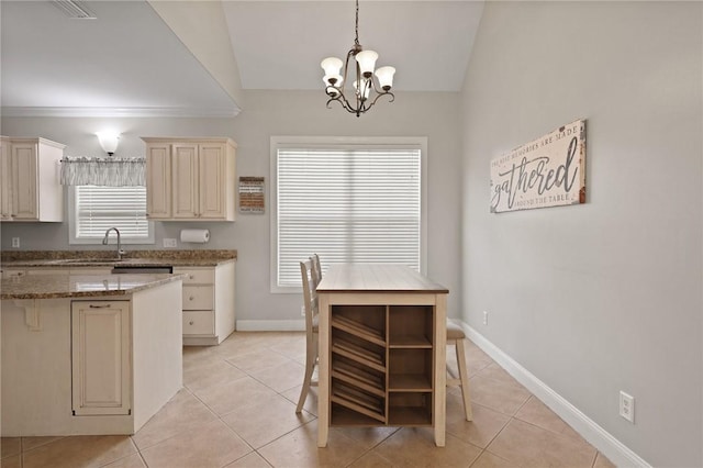 kitchen featuring light tile patterned floors, a chandelier, and cream cabinets