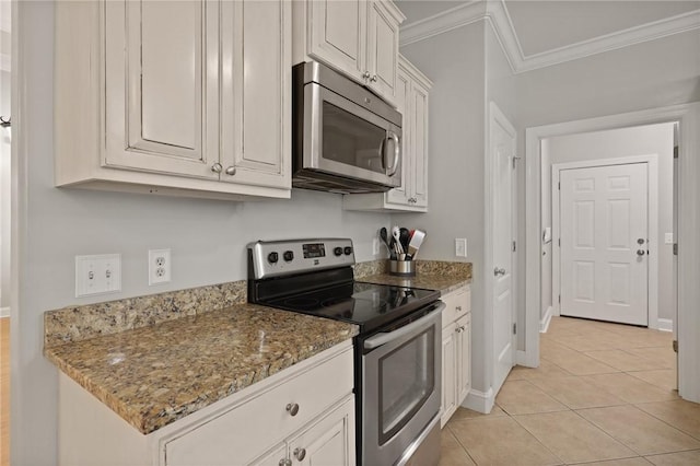 kitchen featuring stainless steel appliances, light stone counters, ornamental molding, and light tile patterned flooring