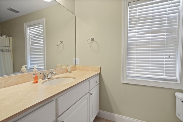 bathroom with vanity, baseboards, tile patterned flooring, and visible vents