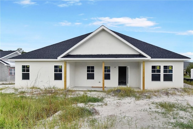 rear view of house with covered porch